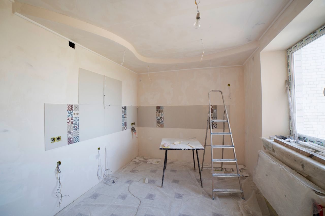About Spacious kitchen under renovation with ladder and tools, showcasing a fresh new design.